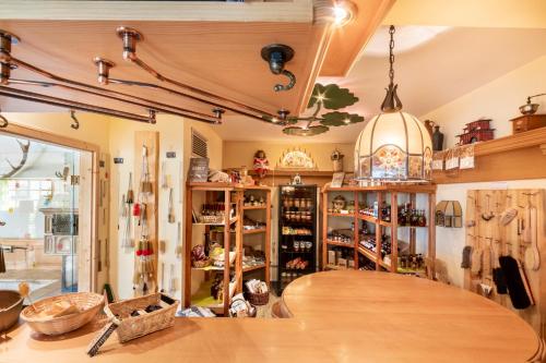 a shop with a large wooden table in a room at Hotel Forstmeister in Schönheide