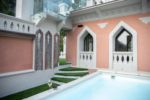 an image of a house with a swimming pool at La Portineria Luxury B&B in Piancogno