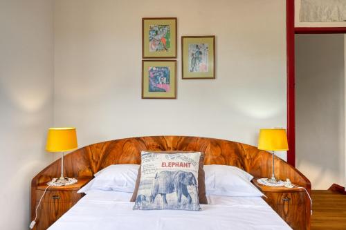 a bed with a pillow on it with two lamps at Os Ferreirinhos, a Home in Madeira in São Jorge