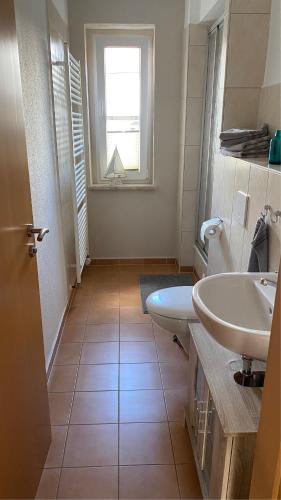 a bathroom with two sinks and a window at Alte Feuerwehr Bleicherode in Bleicherode
