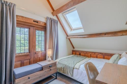 a bedroom with a bed and a window at Barns Lee in Malmesbury