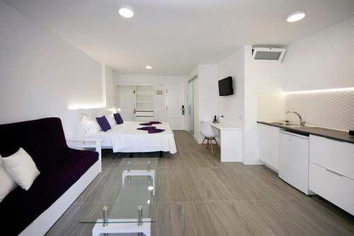 a living room with a couch and a bed in a room at Skyview Hotel Tenerife in Puerto de la Cruz