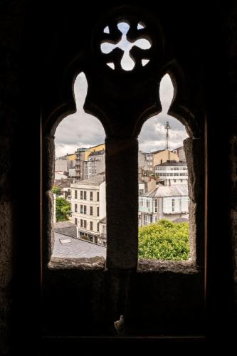 a view of a city from a window at Parador de Vilalba in Villalba