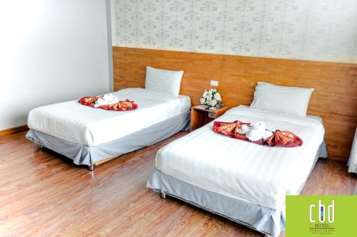 Ένα ή περισσότερα κρεβάτια σε δωμάτιο στο CBD Hotel Suratthani