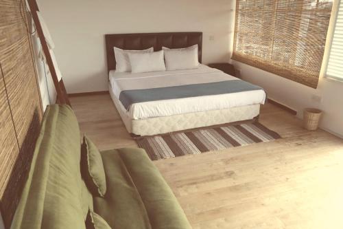 a small bedroom with a bed and a window at Alakamandava in Colombo
