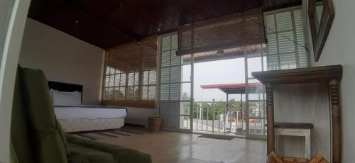 a bedroom with a bed and a fireplace and windows at Alakamandava in Colombo