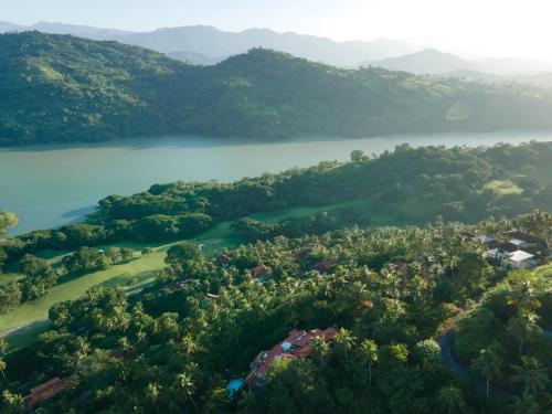 an aerial view of a golf course next to a lake at The Albatross, Kandy in Digana