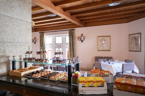 a bakery with a variety of pastries on a counter at Parador de Vilalba in Villalba