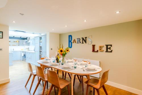 a dining room with a table and chairs at Barns Lee in Malmesbury