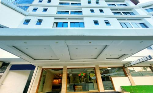 a large white building with windows in front of it at Green Park Residency in Kannur