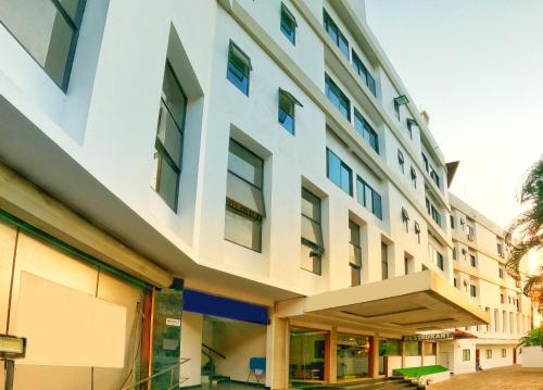 an office building with a white facade at Green Park Residency in Kannur