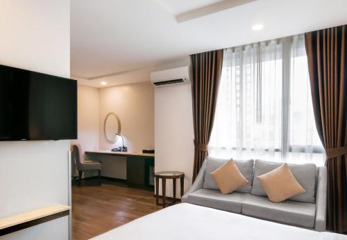 Ένα ή περισσότερα κρεβάτια σε δωμάτιο στο SureStay Plus by Best Western Sukhumvit 2