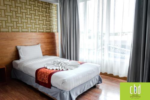 Ένα ή περισσότερα κρεβάτια σε δωμάτιο στο CBD Hotel Suratthani