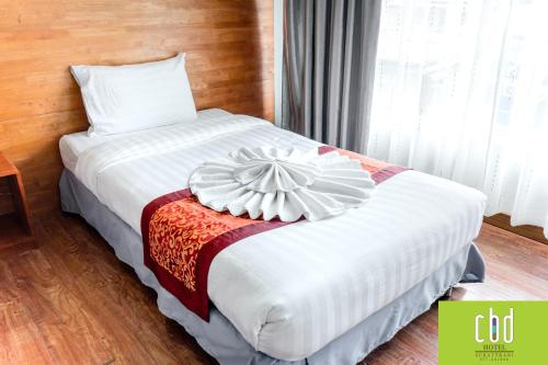 Ένα ή περισσότερα κρεβάτια σε δωμάτιο στο CBD Hotel Suratthani