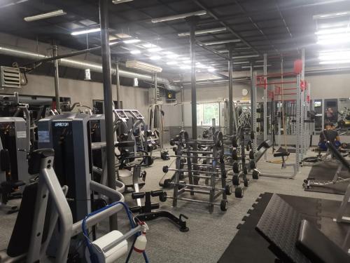 a gym with lots of weights and tread machines at APARTAMENT NAD JEZIOREM in Sława