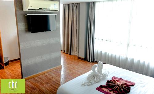 Ένα ή περισσότερα κρεβάτια σε δωμάτιο στο CBD Hotel Suratthani