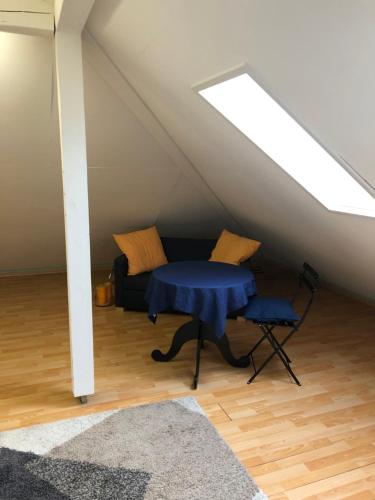 a room with a table and a couch in a attic at Zurich Studio in Birmensdorf