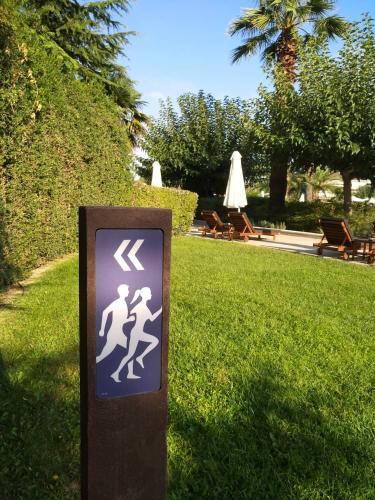 a sign in the grass in a park at Hyatt Regency Thessaloniki in Thessaloniki