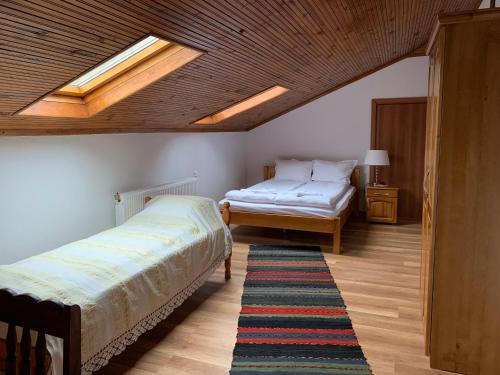 a bedroom with two beds and a ceiling with a skylight at Сининкова Къща in Melnik