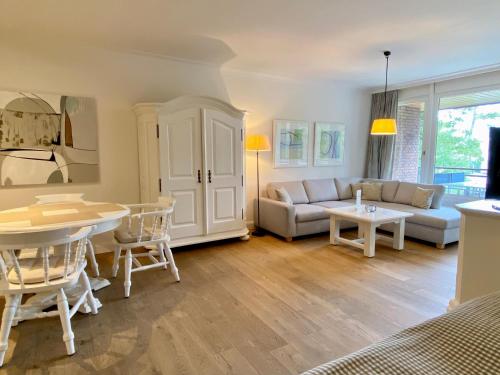 a living room with a couch and a table at Appartement-Hotel Timmendorfer Strand in Timmendorfer Strand