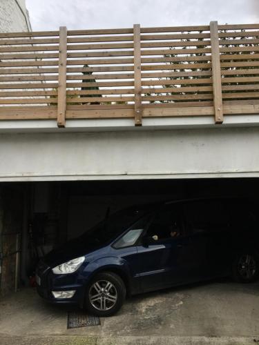 a small blue car parked under a bridge at Character cottage in the heart of Uplyme. in Uplyme
