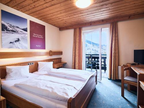 Voodi või voodid majutusasutuse Hotel Kirchboden by Alpeffect Hotels toas
