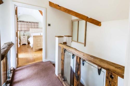 a hallway with a stairway leading to a bedroom at Bence Farm Yorkshire, barn conversion with hot tub karaoke great views between leeds and sheffield 