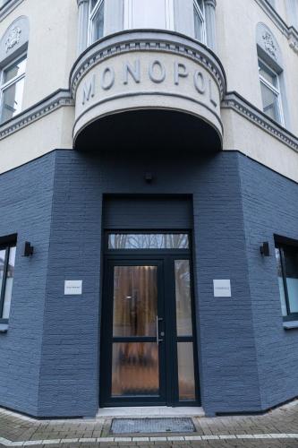 a building with a sign on the front of it at Hotel Monopol in Hilden
