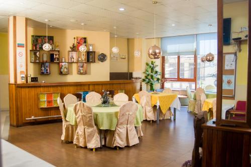 a restaurant with tables and chairs in a room at Hotel Cristal Madagascar in Antananarivo