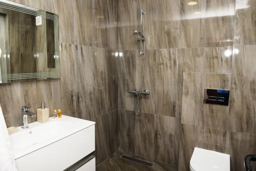 a bathroom with a shower and a sink at Вила Релакс in Smolyan