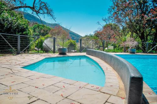 a swimming pool in a yard with a fence at Avoca Vale Country Hotel in Louis Trichardt