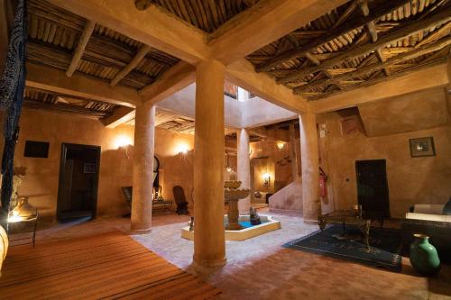 a large living room with a large wooden ceiling at Dar Kamar in Ouarzazate
