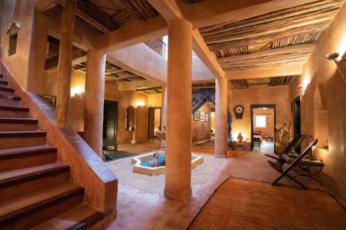 a living room with a staircase and a tub in the middle at Dar Kamar in Ouarzazate