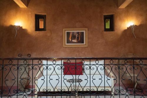 a balcony with a iron fence and a painting on a wall at Dar Kamar in Ouarzazate