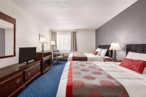 a hotel room with two beds and a flat screen tv at Ramada by Wyndham Arcata in Arcata