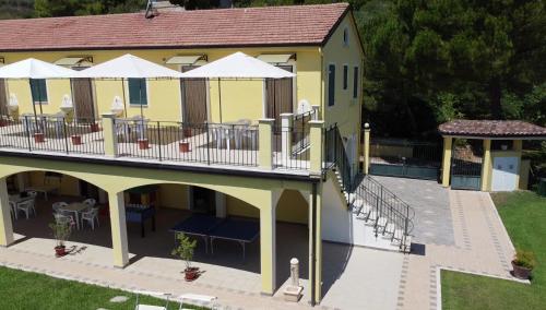 an aerial view of a yellow building with tables and chairs at Agriturismo MonteMaggio in Lapedona