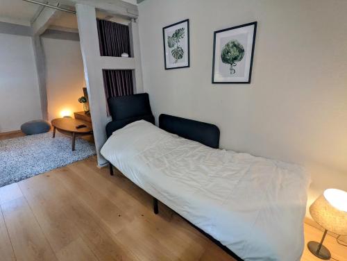 une chambre avec un lit, une table et des chaises dans l'établissement CityCosy Strasbourg - Authentique Batelier, à Strasbourg