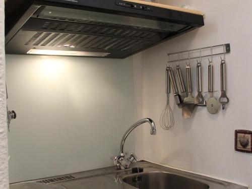 a kitchen with a sink and a stove top oven at Studio Lanslevillard, 1 pièce, 2 personnes - FR-1-508-235 in Lanslebourg-Mont-Cenis