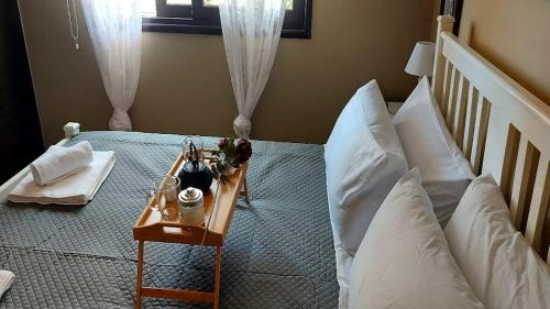 a bedroom with a bed with a table on it at Paramount Gardens Resorts C202 in Larnaka