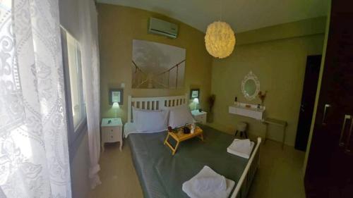 a bedroom with a large bed and a chandelier at Paramount Gardens Resorts C202 in Larnaka