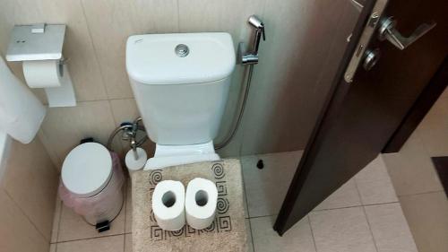 a small bathroom with a toilet and a sink at Paramount Gardens Resorts C202 in Larnaka