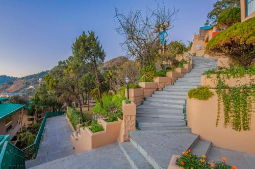 a set of stairs leading up to a building with plants at Sterling Mussoorie in Mussoorie