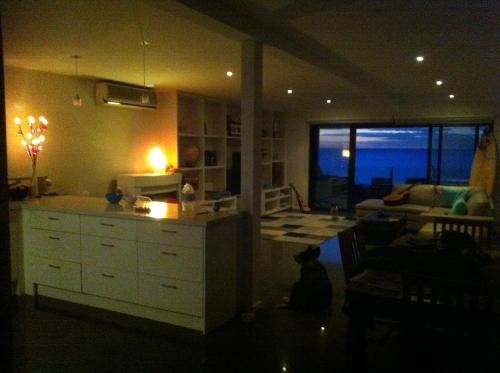 uma cozinha e sala de estar com vista para o oceano em Award Winning Beach Front Retreat em Frankston