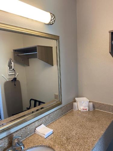 a bathroom with a sink and a mirror at Red Roof Inn Vero Beach - I-95 in Vero Beach
