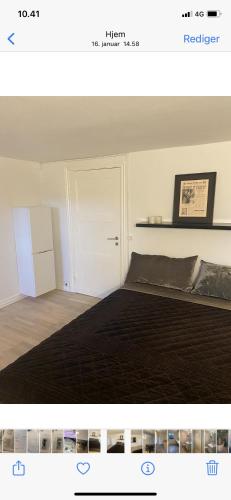 a bedroom with a bed and a white refrigerator at Hellerup - suite 1 in Hellerup