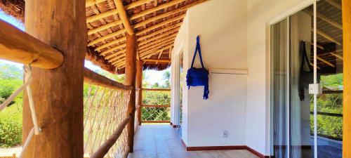 a hallway of a house with a wooden ceiling at Sirena Village in São Miguel do Gostoso
