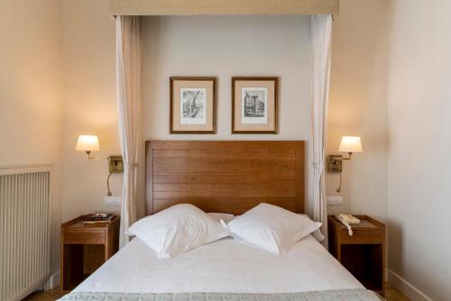 a bedroom with a large bed with two night stands at Parador de Teruel in Teruel