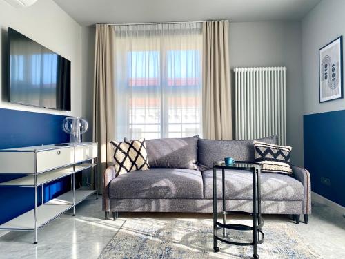 a living room with a couch and a table at H11 Aparthotel in Kraków
