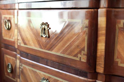 a close up of a wooden chest of drawers at Relais & Château Louise de La Vallière in Reugny