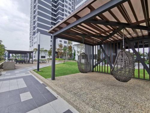 a park with benches and swings in a building at 4 Traders Garden 1 Bedroom Pool View Netflix WiFi in Cheras